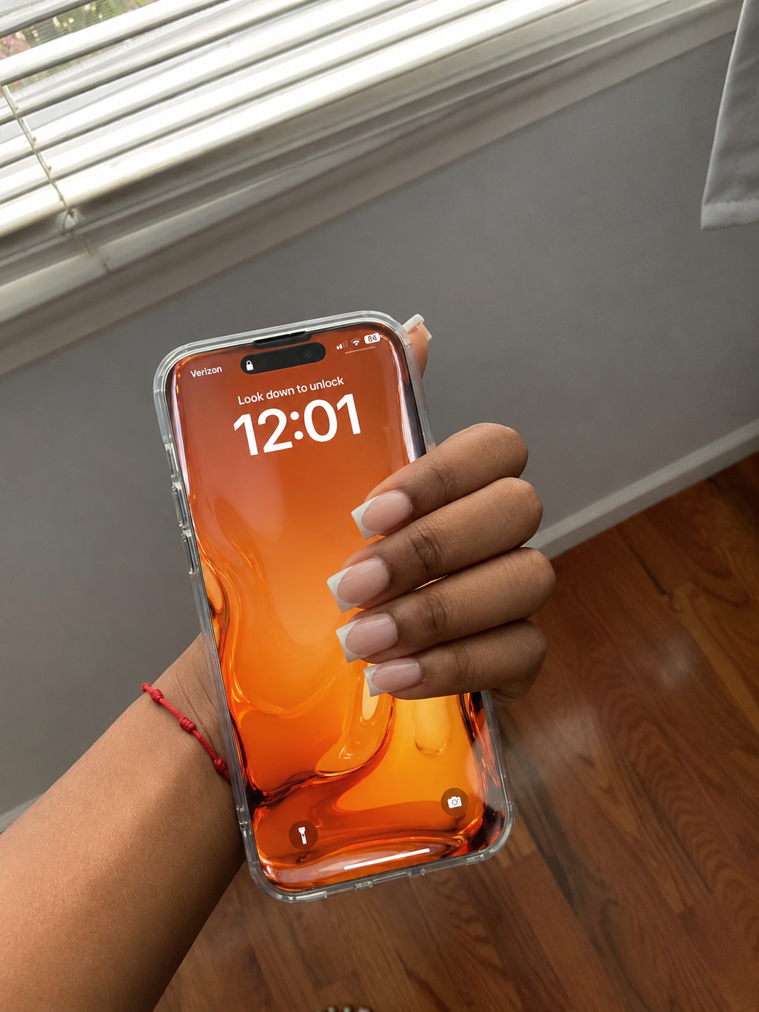 Customer photo — orange liquid glass lock screen